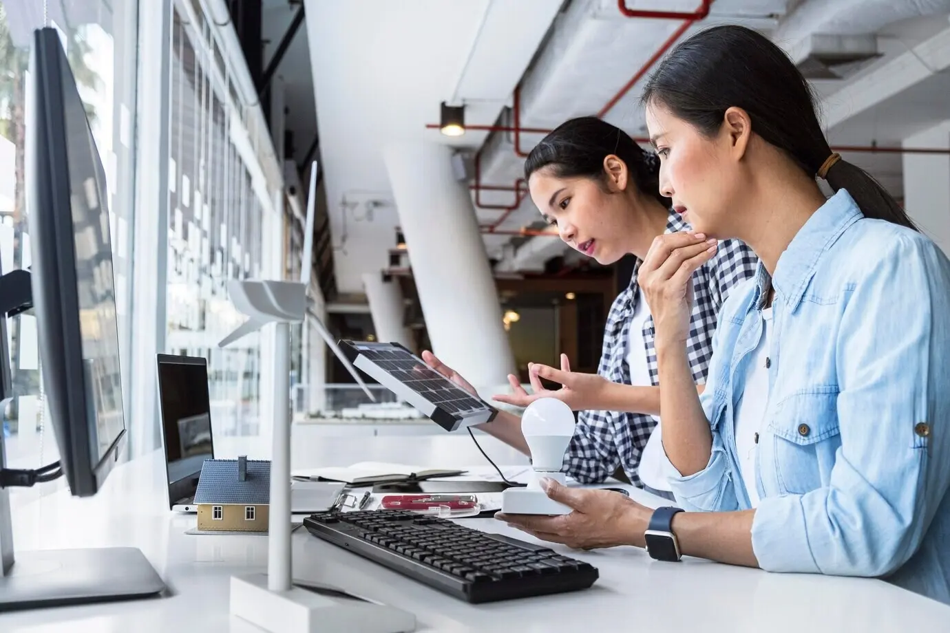 Women collaborating diligently on an innovation at the office
